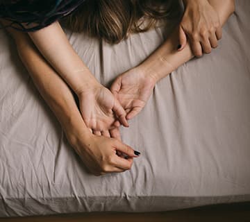 Couple hands on bed