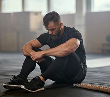 man resting before workout in gym