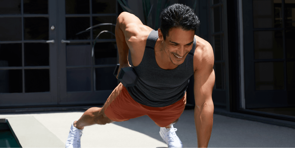 Man doing pushup with dumbbell