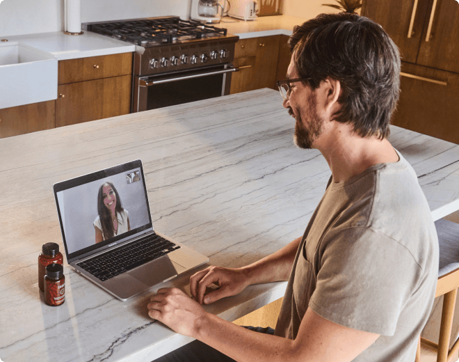Man on laptop meeting with his Clinician